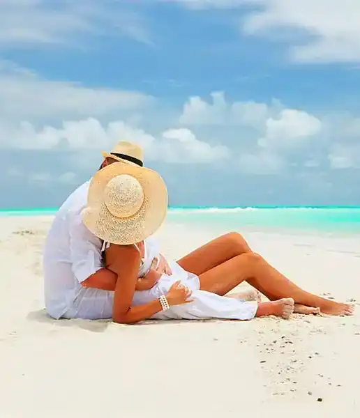 A couple embracing on a white-sand beach