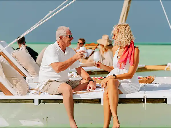 Friends sharing drinks on the deck of a boat off Zanzibar
