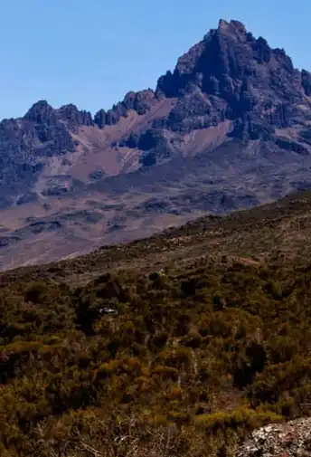 A jagged volcanic peak rising above the moorland on Kilimanjaro