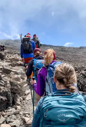 Climbers on a steep, rocky section of the trail